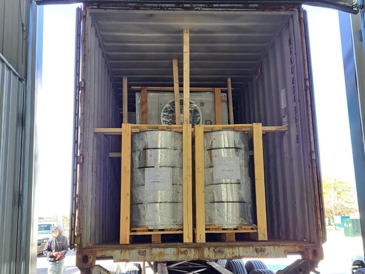 Machinery blocked and braced with lumber inside a container at the dock door