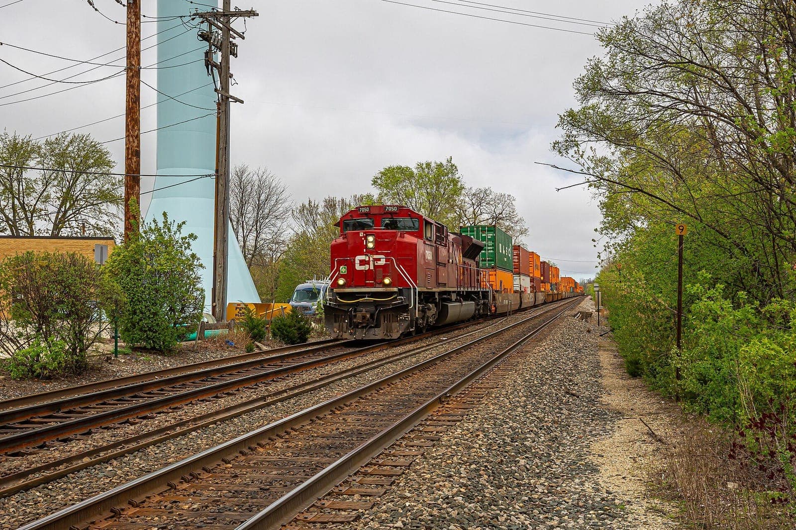 CPKC locomotive leading a double-stacked intermodal container train
