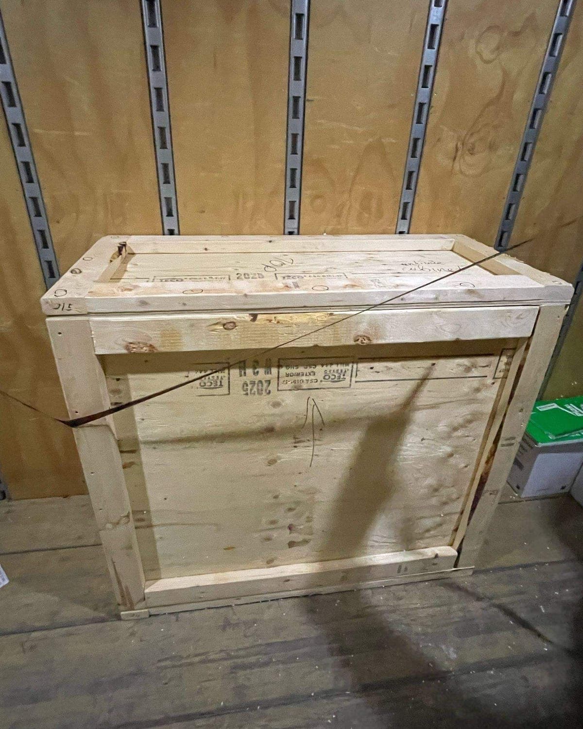 Antique cabinet in a custom crate strapped inside the truck