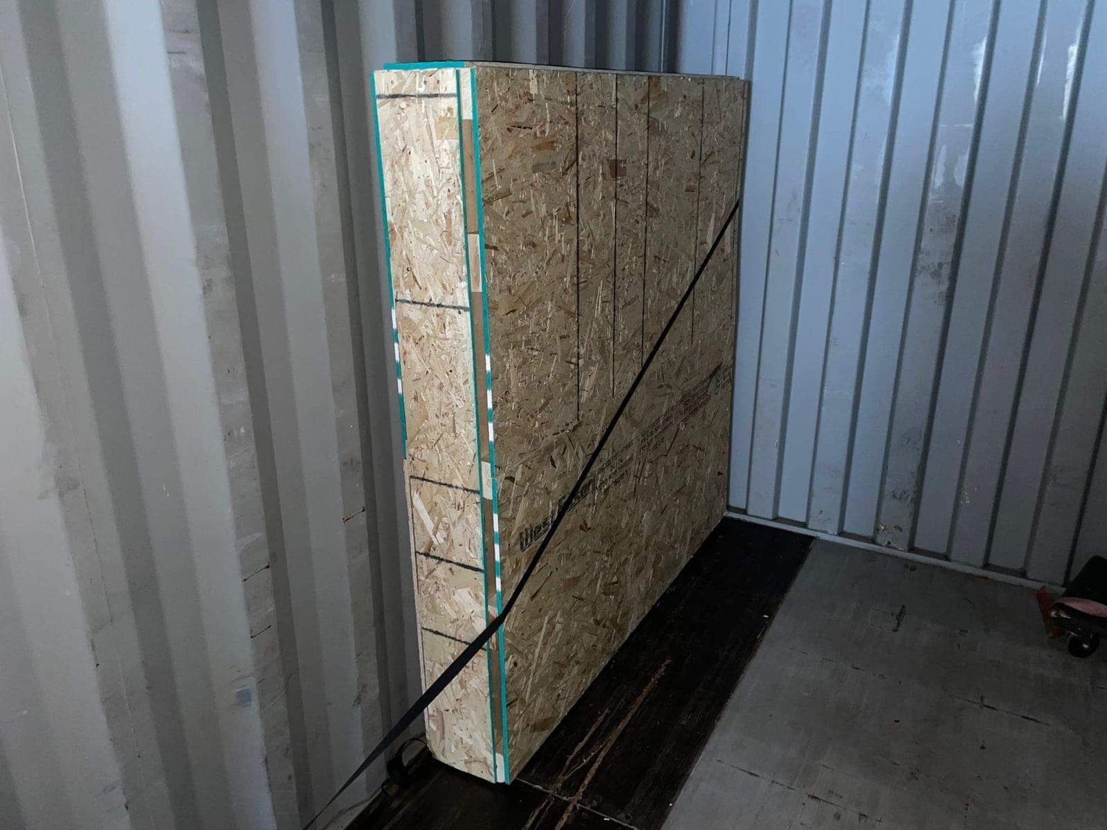 Custom OSB vault strapped to the wall inside a shipping container