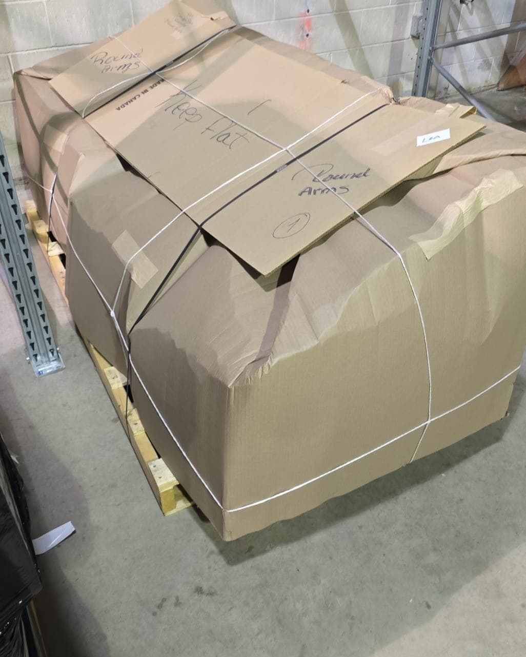 Sofa packed in a custom cardboard carton labelled round arms, keep flat