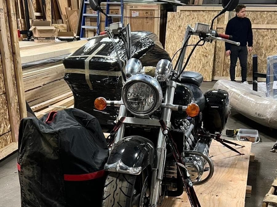 Cruiser strapped to its base with luggage bags secured, packed and ready to move