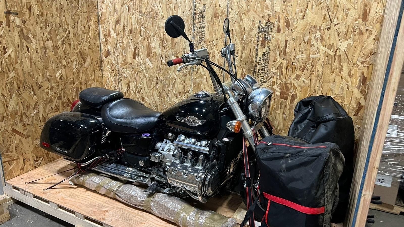 Honda Valkyrie cruiser strapped inside its crate with padding beneath the engine