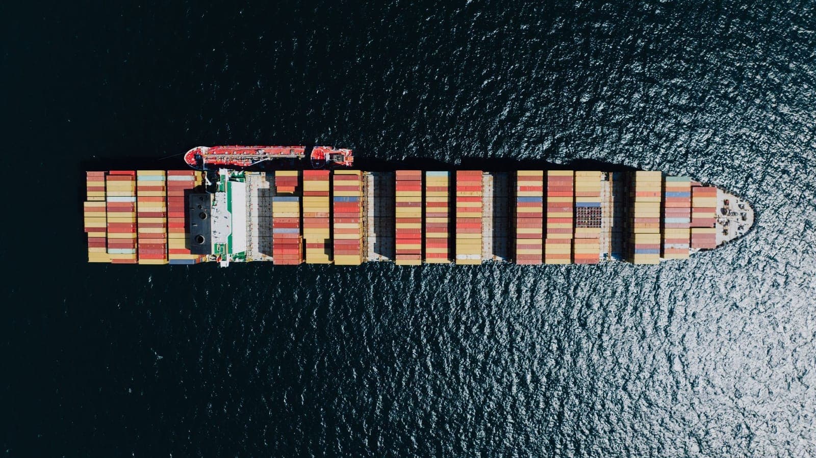Loaded container ship at sea seen from directly above