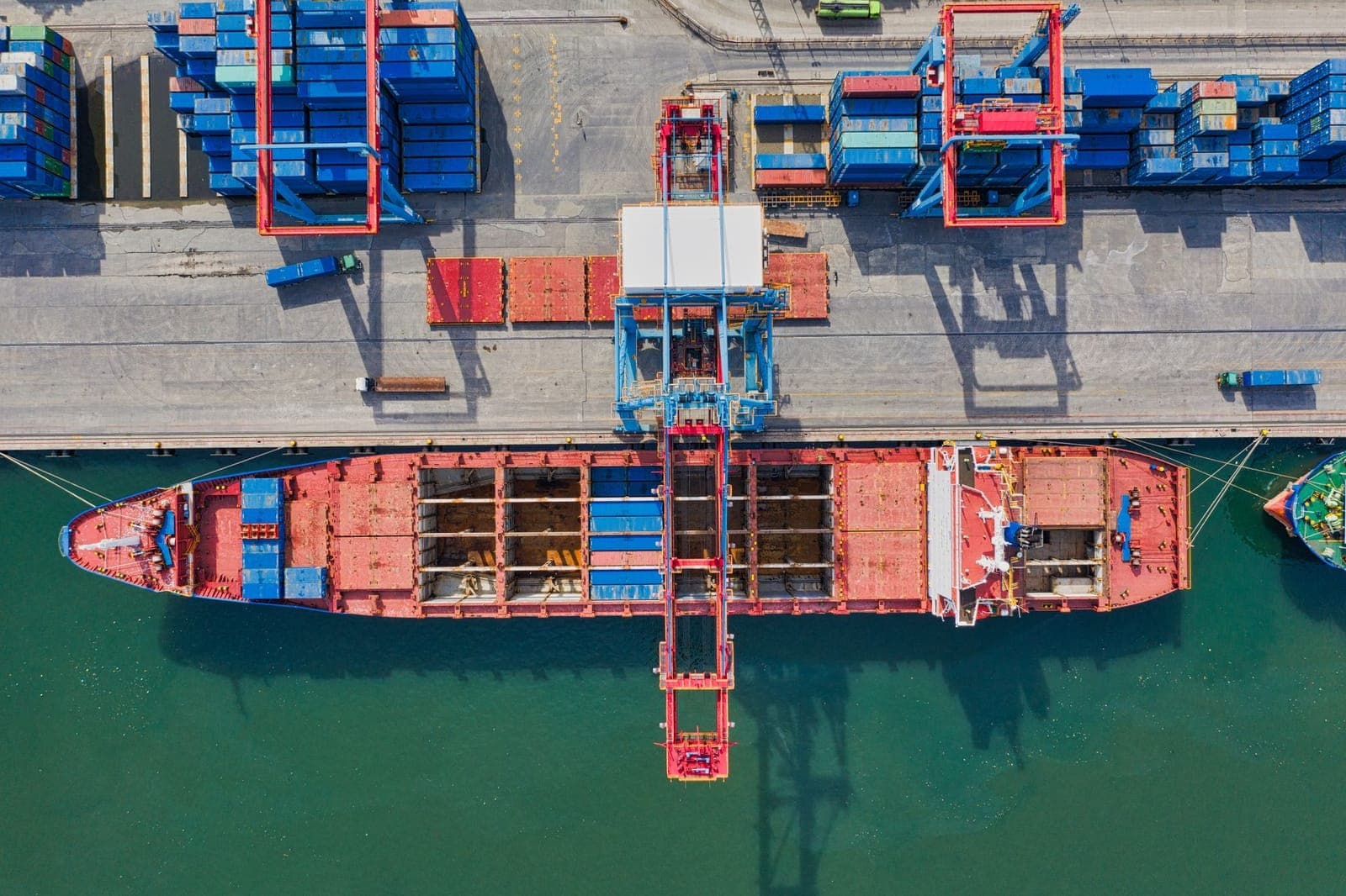 Container ship worked at the berth, seen from above the gantry crane