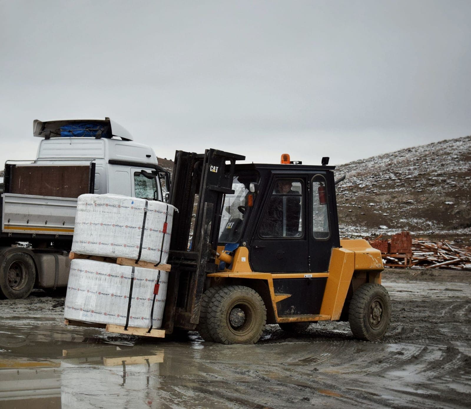 Wrapped and banded pallets being loaded onto a truck
